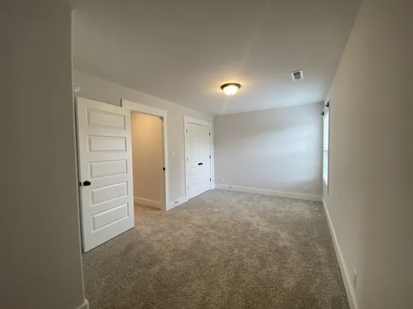 a view of hallway with bathroom