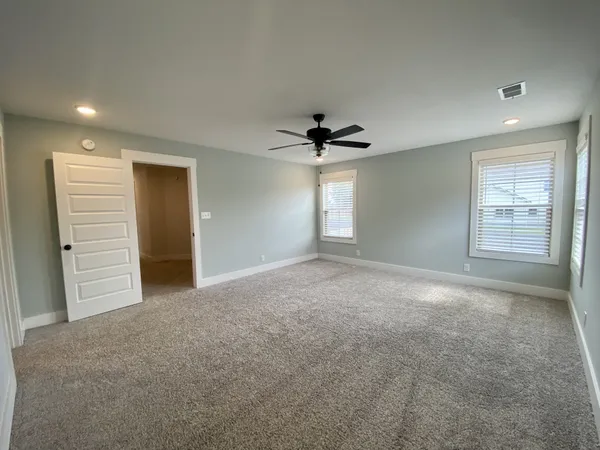 a view of a livingroom with a ceiling fan and window