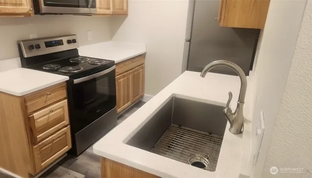 a kitchen with a stove and a microwave