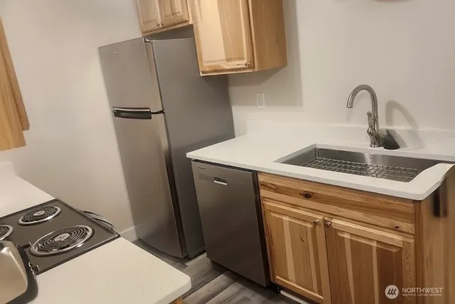 a close view of a sink a washer and dryer