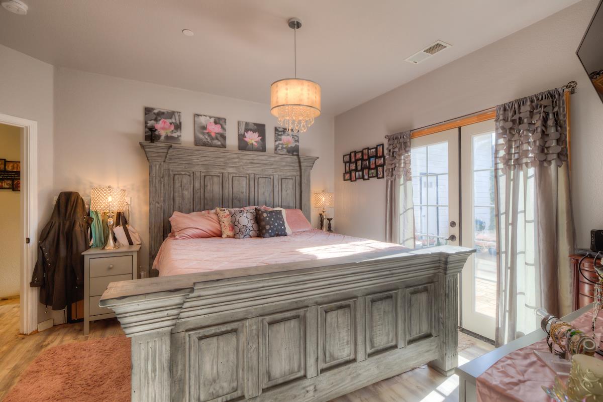 83 Northfork Road Berry Creek, CA 95916 - Photo 39 of 56 a bedroom with a bed and a chandelier