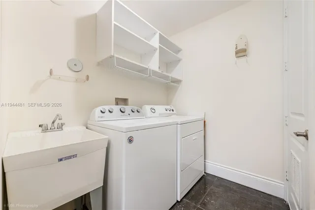 a utility room with sink dryer and washer