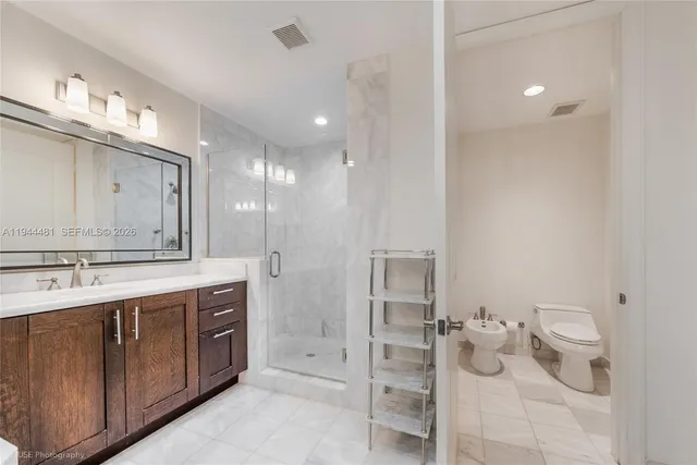 a spacious bathroom with a granite countertop sink mirror and toilet
