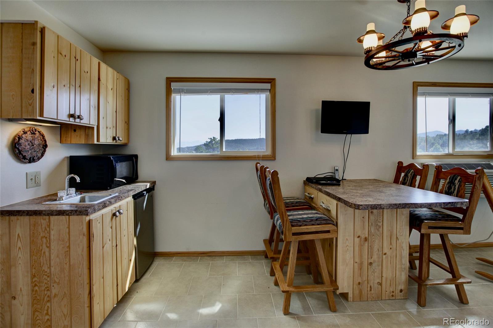 530 Red Feather Road Cotopaxi, CO 81223 - Photo 43 of 46 a kitchen with stainless steel appliances granite countertop a sink a stove and a refrigerator