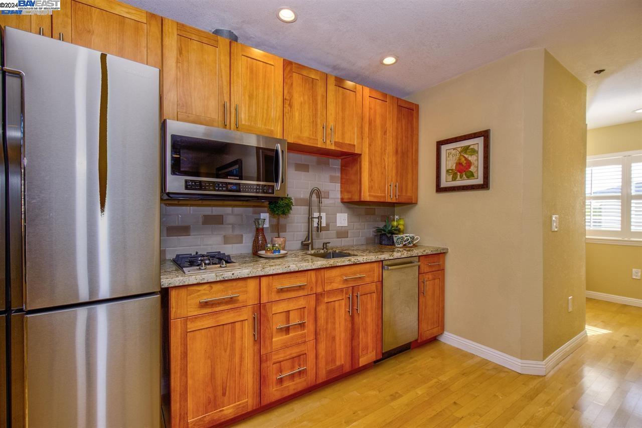 1746 3rd Street, Unit B Livermore, CA 94550 - Photo 6 of 12 a kitchen with stainless steel appliances granite countertop a refrigerator and a sink