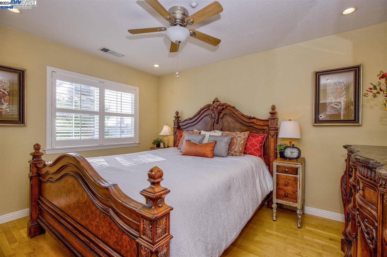 1746 3rd Street, Unit B Livermore, CA 94550 - Photo 7 of 12 a bedroom with a bed and a chandelier