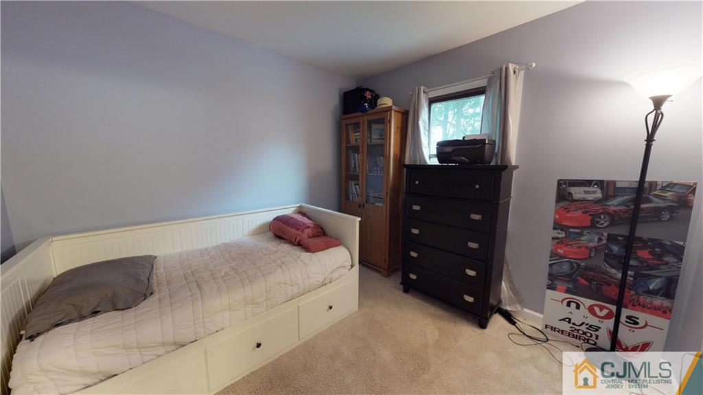 41 Idlewild Road Edison, NJ 08817 - Photo 8 of 23 a bedroom with a bed and a mirror