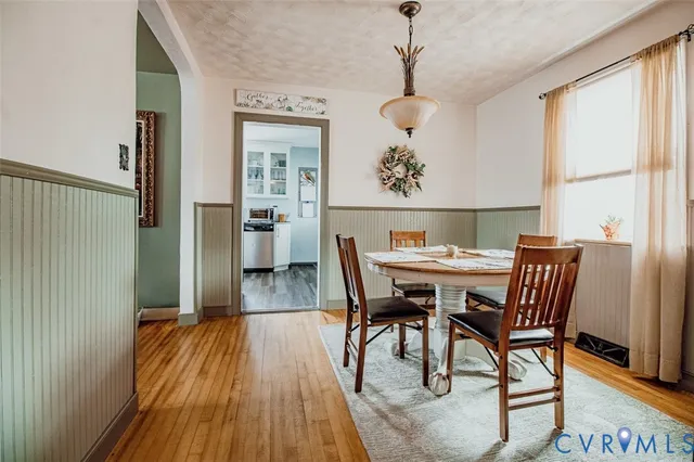 a view of a dining room with furniture window and wooden floor