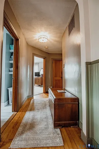 a room with a walk in closet and wooden floor