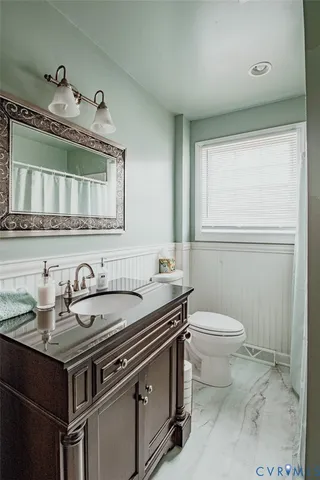 a bathroom with a sink toilet and mirror