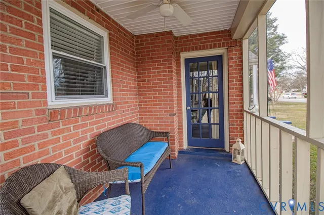 a view of a porch with furniture and a yard
