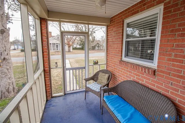 a view of a balcony with chair and wooden floor