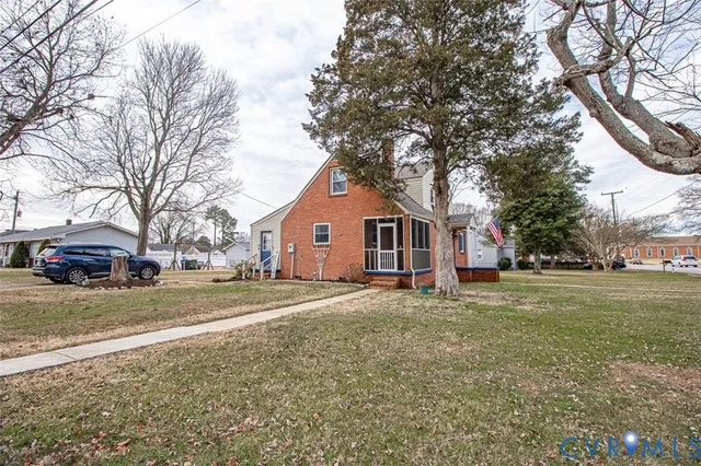 a view of a yard with a house and a large tree