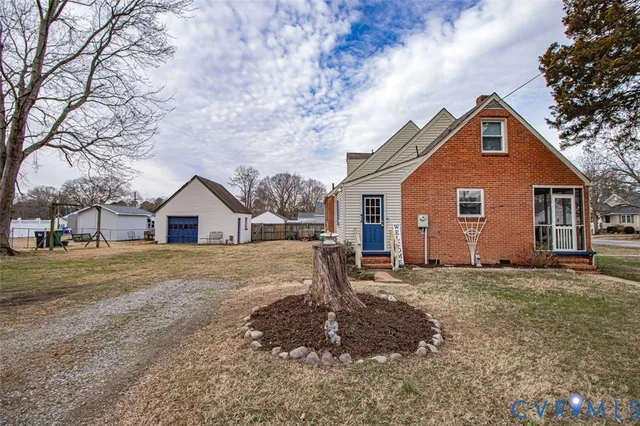 a view of a house with a yard covered in snow