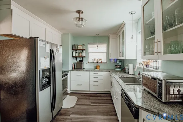 a kitchen with stainless steel appliances a refrigerator sink and stove
