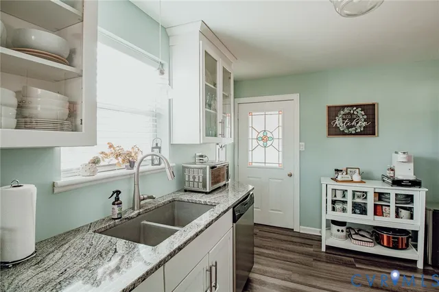 a kitchen with a sink and a stove top oven