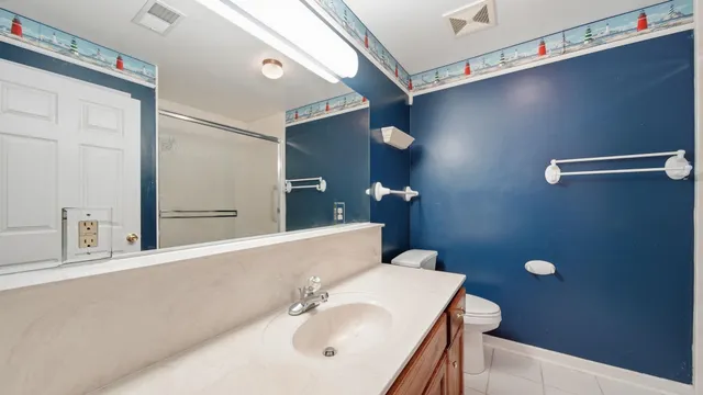 a bathroom with a sink a mirror and a toilet