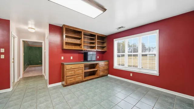 a view of kitchen with stainless steel appliances granite countertop a stove and a cabinets