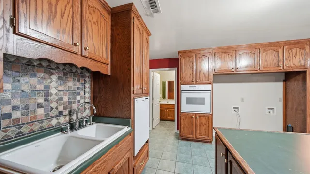 a kitchen with stainless steel appliances granite countertop a refrigerator and a stove