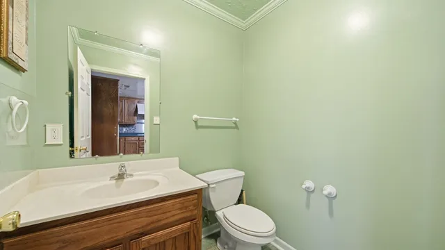 a bathroom with a sink a toilet and mirror