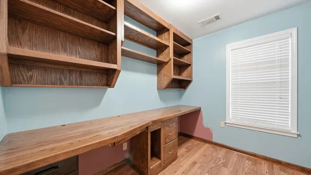 a view of walk in closet with empty racks