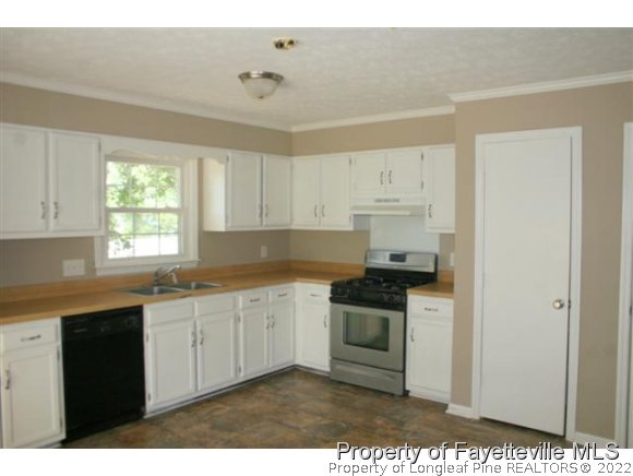 5212 Rockingham Road Fayetteville, NC 28311 - Photo 3 of 19 a kitchen with stainless steel appliances granite countertop a stove a sink and a refrigerator