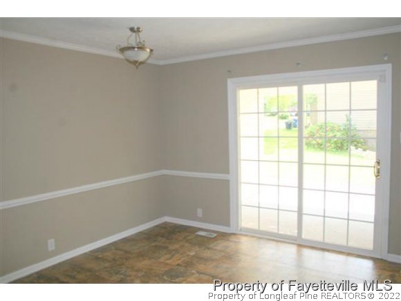 5212 Rockingham Road Fayetteville, NC 28311 - Photo 4 of 19 a view of an empty room with a window