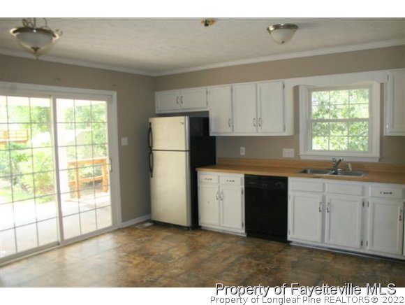 5212 Rockingham Road Fayetteville, NC 28311 - Photo 8 of 19 a kitchen with a refrigerator and a sink