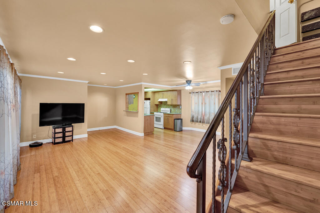 10240 Silverton Avenue, Unit 9 Tujunga, CA 91042 - Photo 12 of 23 a view of a livingroom with wooden floor and staircase