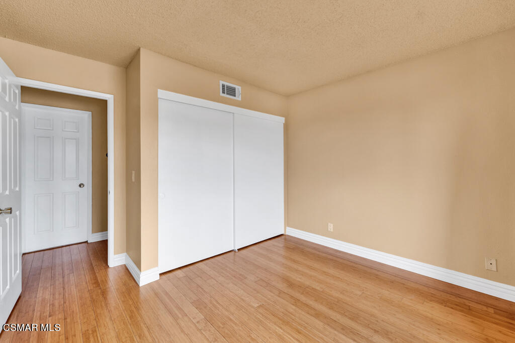 10240 Silverton Avenue, Unit 9 Tujunga, CA 91042 - Photo 13 of 23 a view of an empty room with wooden floor