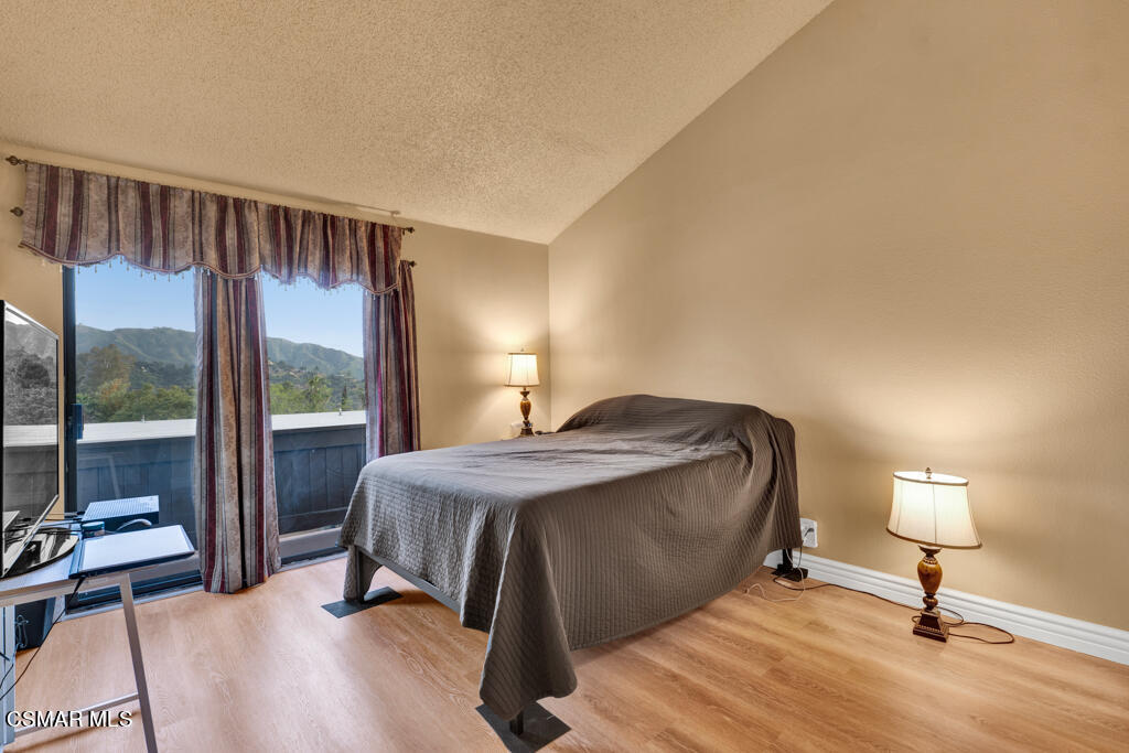 10240 Silverton Avenue, Unit 9 Tujunga, CA 91042 - Photo 14 of 23 a living room with a bed furniture and a large window
