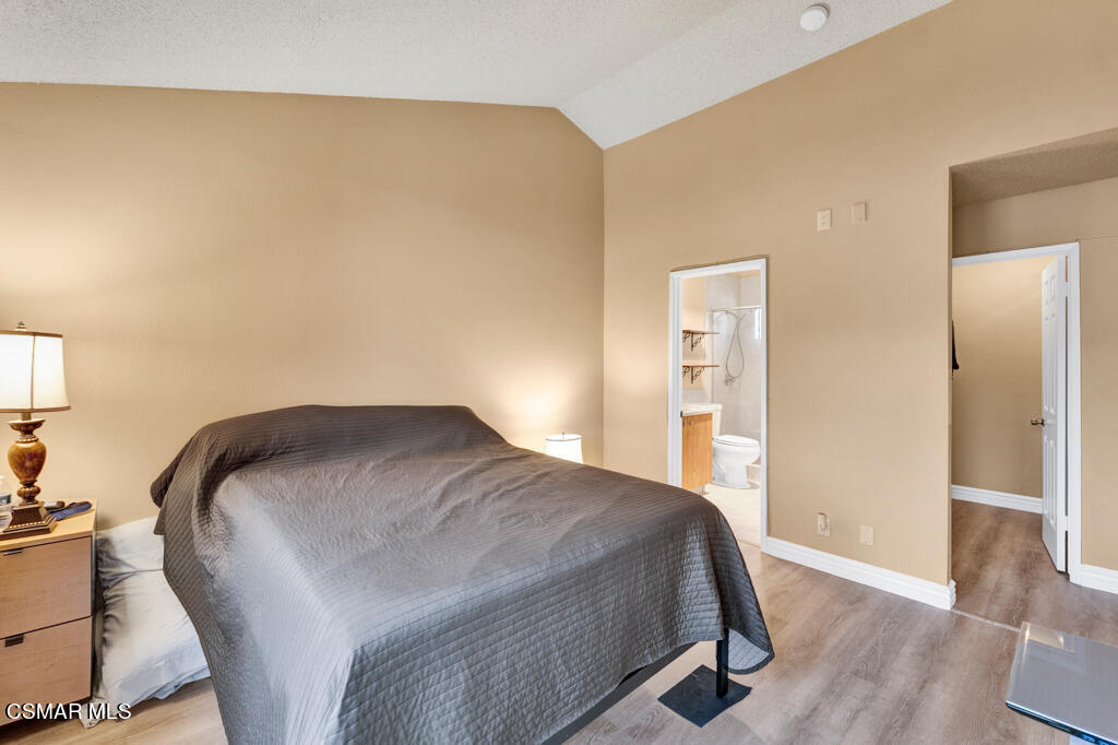 10240 Silverton Avenue, Unit 9 Tujunga, CA 91042 - Photo 15 of 23 a bedroom with a bed and wooden floor