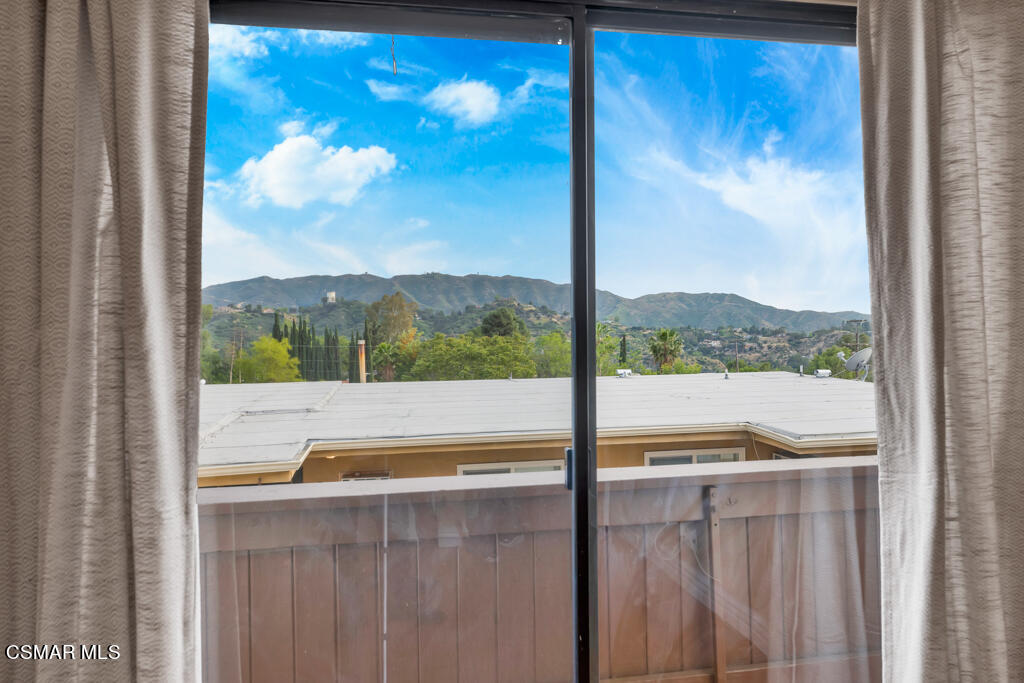 10240 Silverton Avenue, Unit 9 Tujunga, CA 91042 - Photo 18 of 23 a view of a glass door with a tree