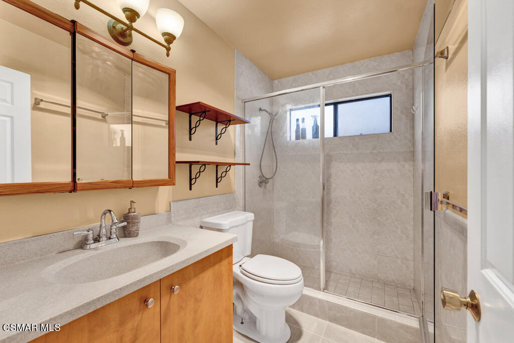 10240 Silverton Avenue, Unit 9 Tujunga, CA 91042 - Photo 20 of 23 a bathroom with a granite countertop sink toilet and shower