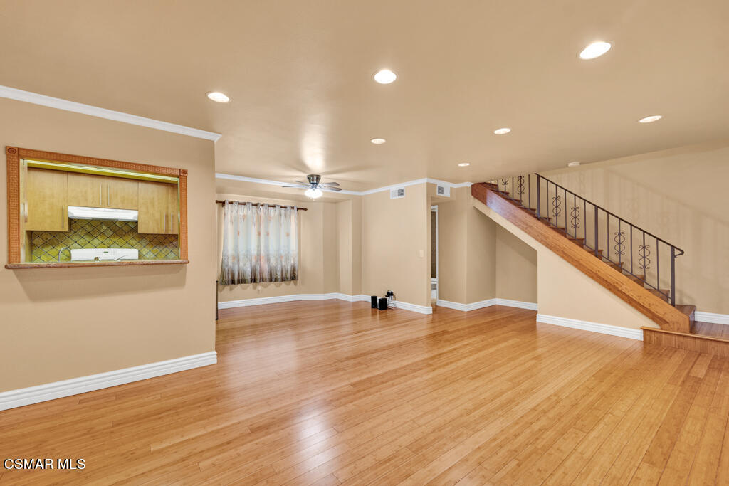 10240 Silverton Avenue, Unit 9 Tujunga, CA 91042 - Photo 2 of 23 a view of an empty room with wooden floor and a window