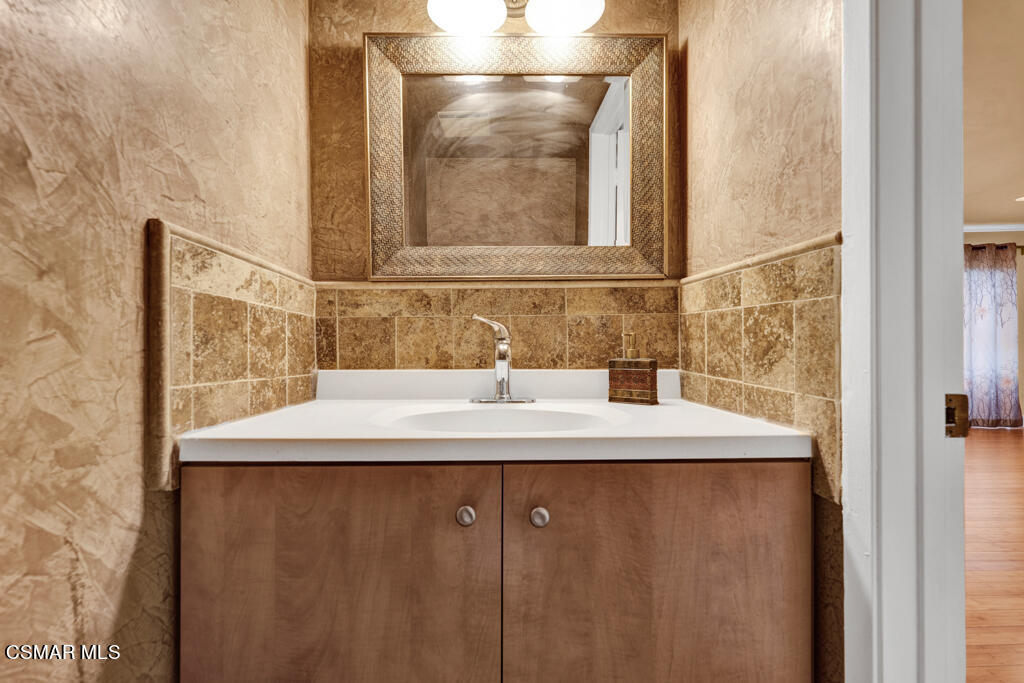 10240 Silverton Avenue, Unit 9 Tujunga, CA 91042 - Photo 21 of 23 a bathroom with a sink and a mirror
