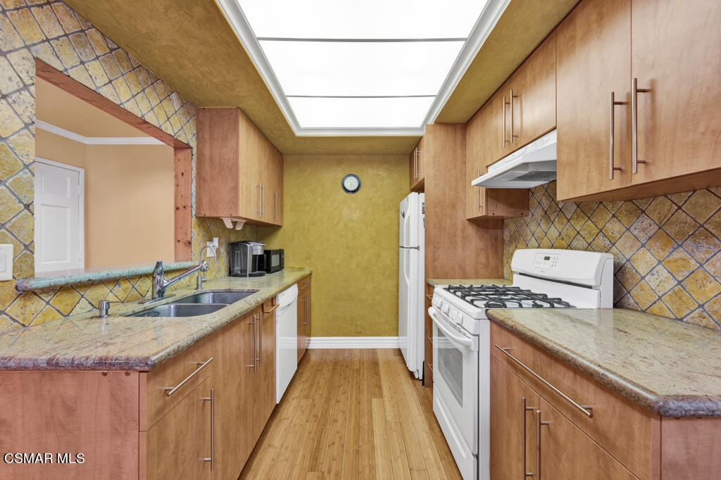 10240 Silverton Avenue, Unit 9 Tujunga, CA 91042 - Photo 5 of 23 a kitchen with stainless steel appliances granite countertop a sink stove and cabinets
