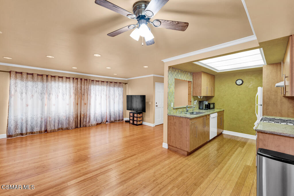 10240 Silverton Avenue, Unit 9 Tujunga, CA 91042 - Photo 7 of 23 a view of an empty room with kitchen and a window