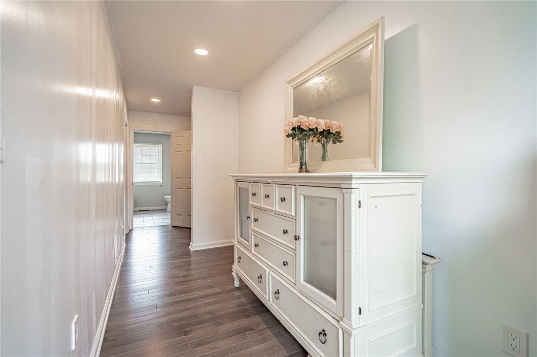 102 Sutton Road Easton, PA 18045 - Photo 39 of 83 Smooth wood-look flooring and recessed lighting line this bright hallway leading to the bathroom.