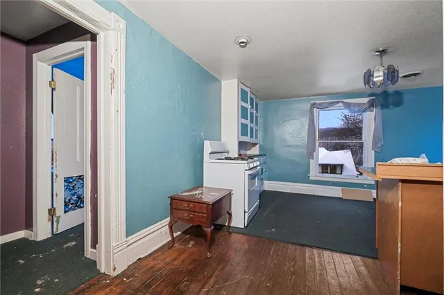 a living room with furniture a piano and a dining table