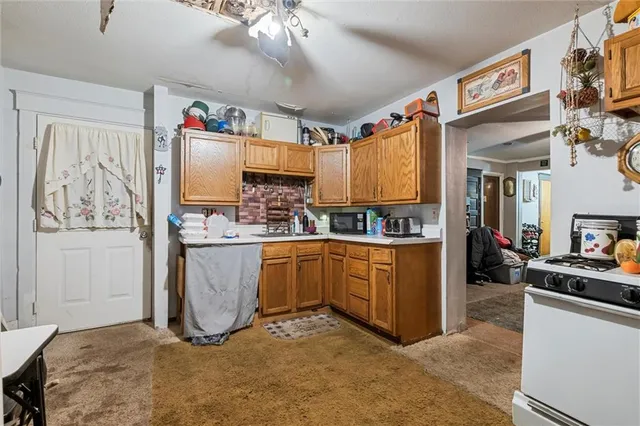 a kitchen with cabinets and window