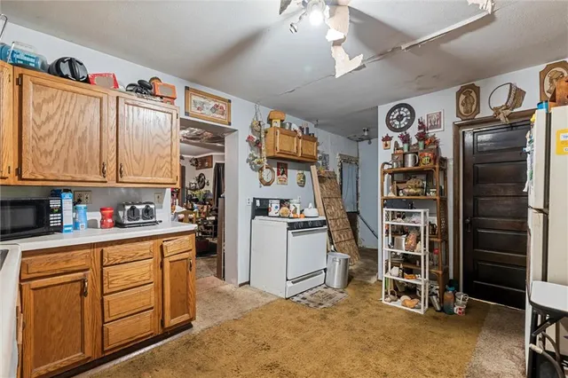 a kitchen with stainless steel appliances granite countertop a refrigerator and cabinets