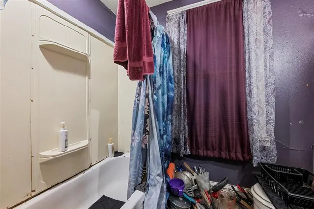 a view of walk in closet with clothes