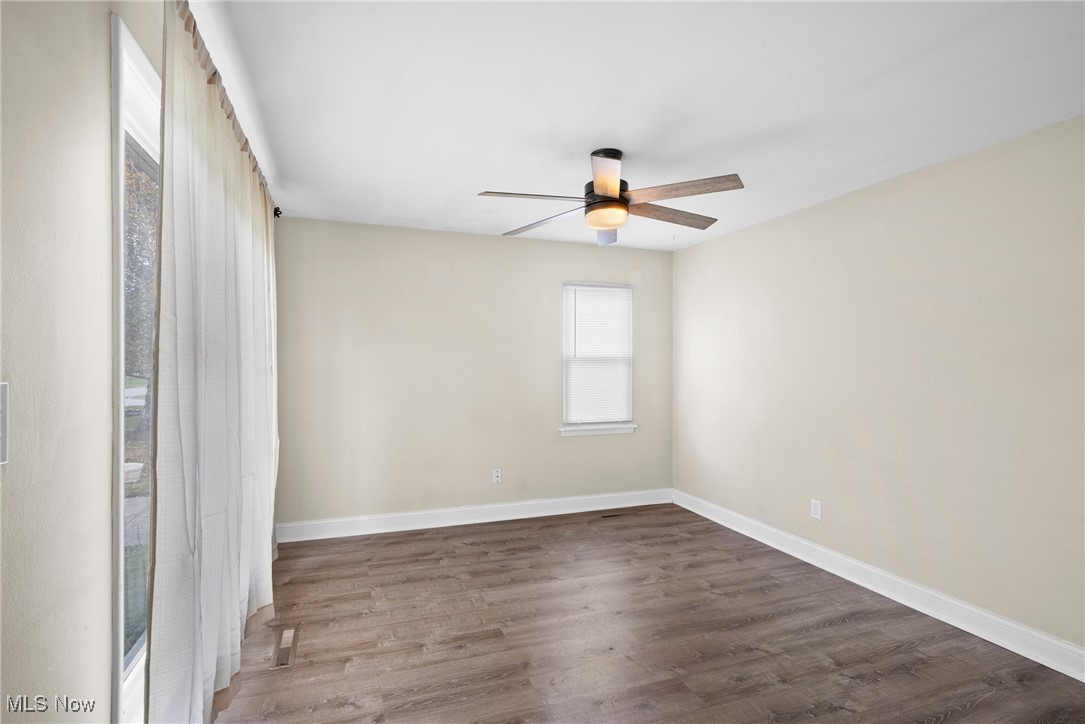 4963 Wake Robin Road Mentor, OH 44060 - Photo 9 of 21 Empty room with dark hardwood / wood-style floors and ceiling fan