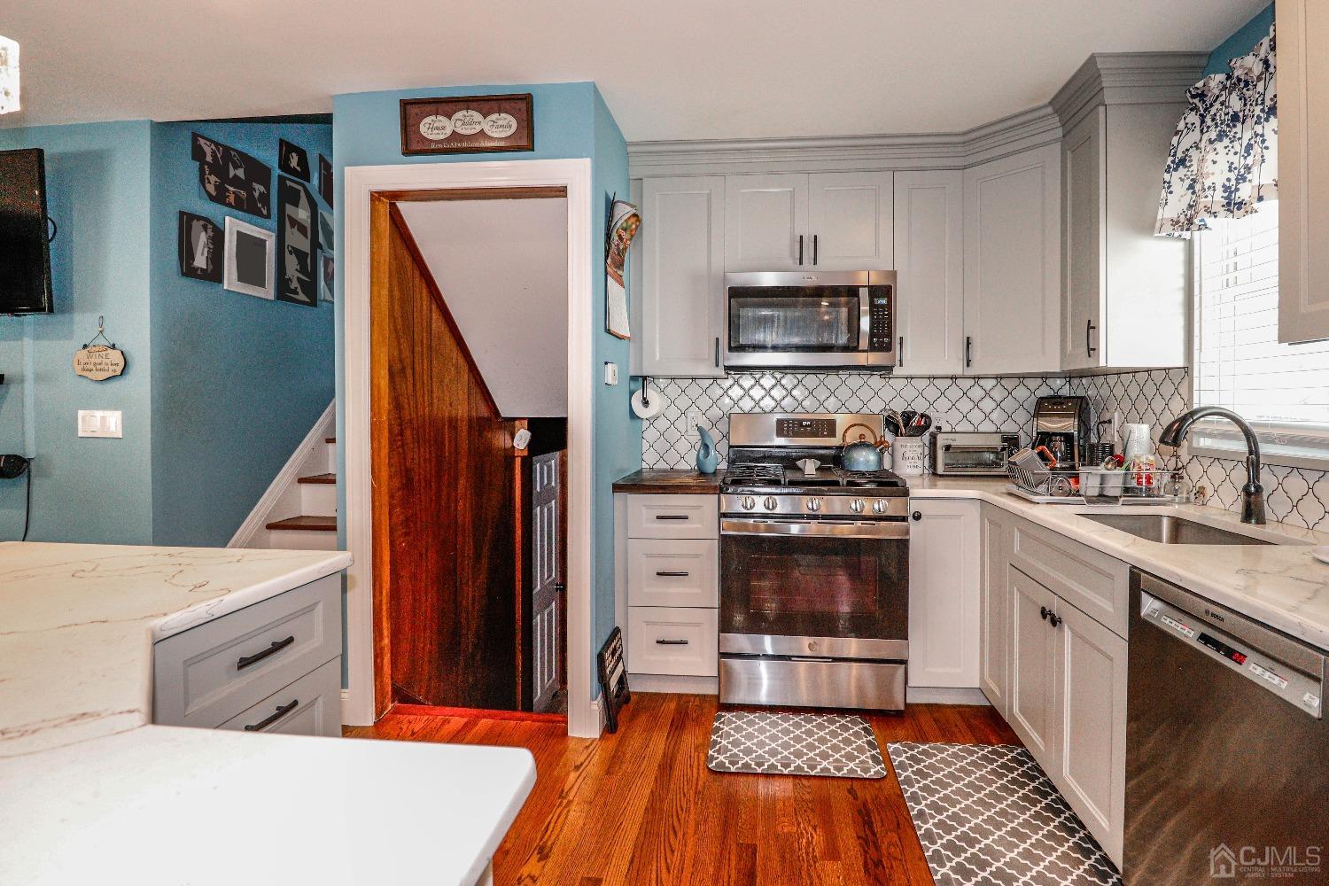 24 Finley Road Edison, NJ 08817 - Photo 11 of 27 a kitchen with granite countertop a refrigerator stove and microwave