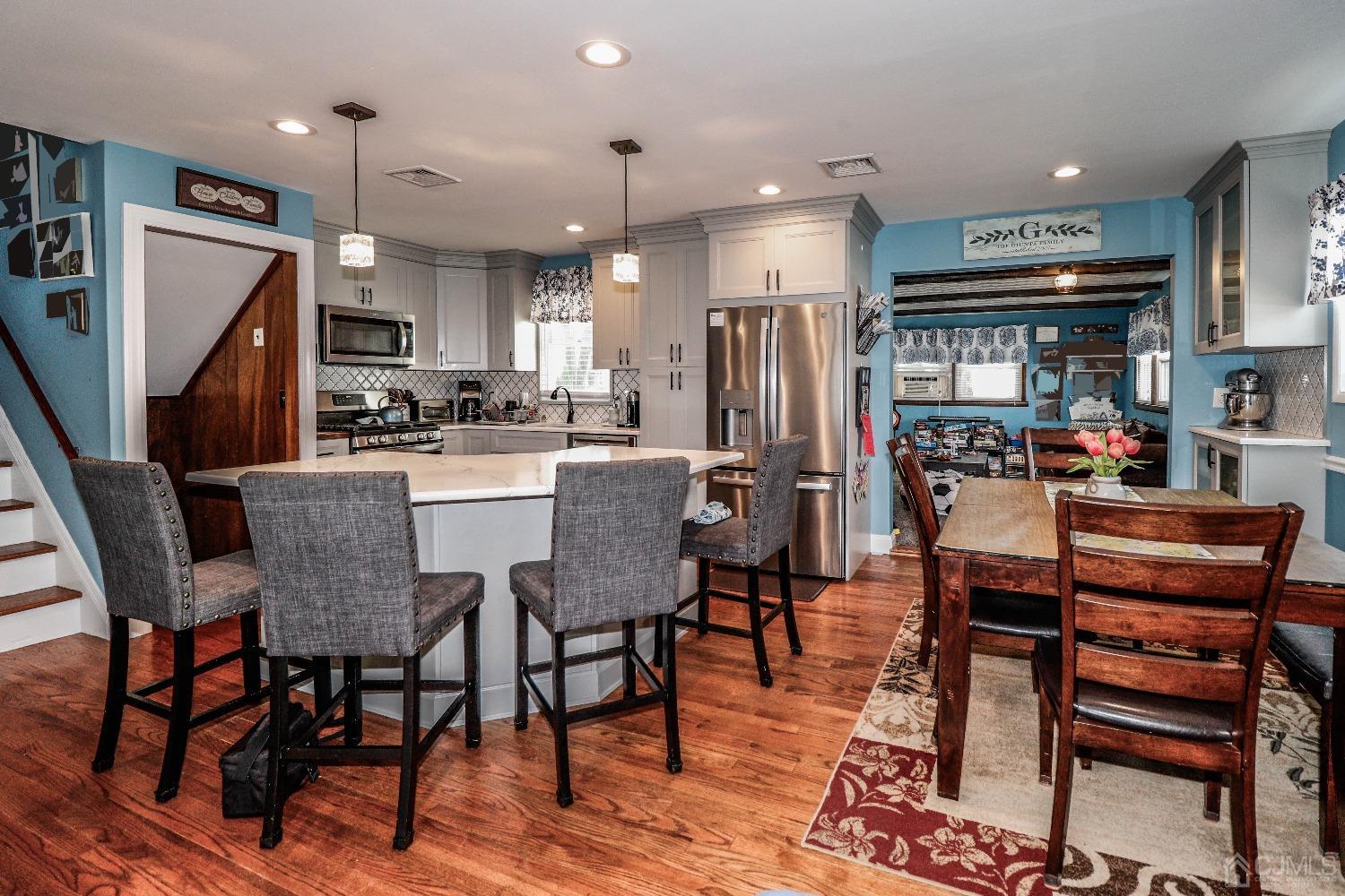 24 Finley Road Edison, NJ 08817 - Photo 14 of 27 a dining area with stainless steel appliances kitchen island granite countertop a dining table chairs and a refrigerator
