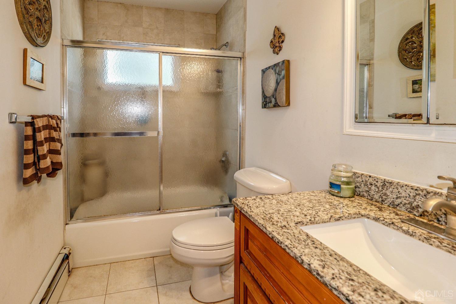 24 Finley Road Edison, NJ 08817 - Photo 19 of 27 a bathroom with a granite countertop sink a toilet and shower