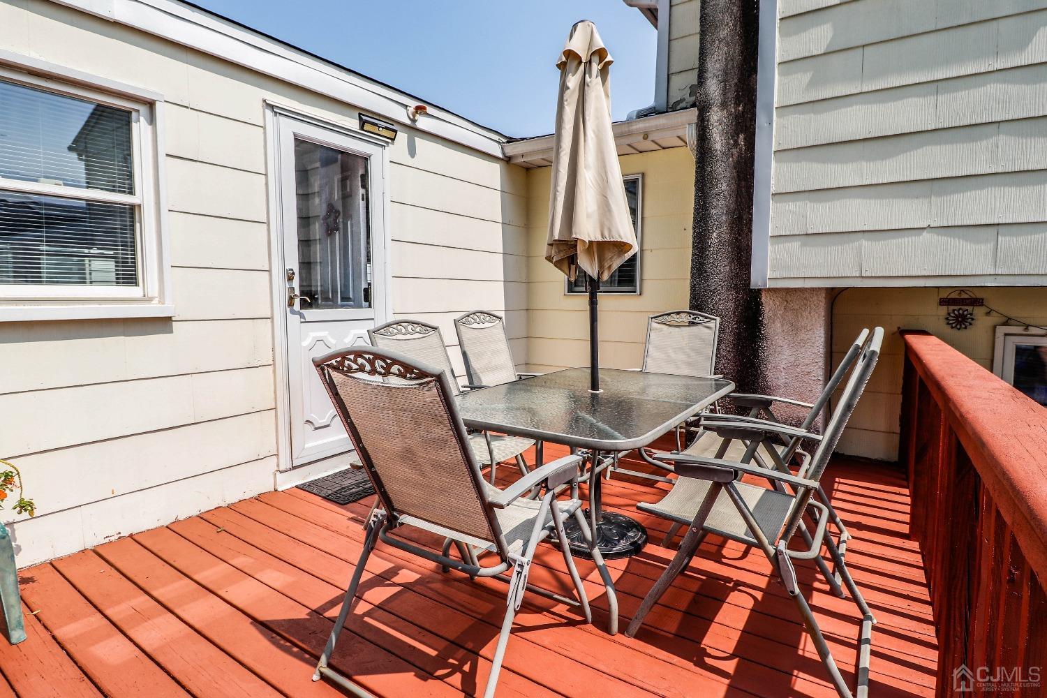 24 Finley Road Edison, NJ 08817 - Photo 24 of 27 a view of a patio with a table and chairs
