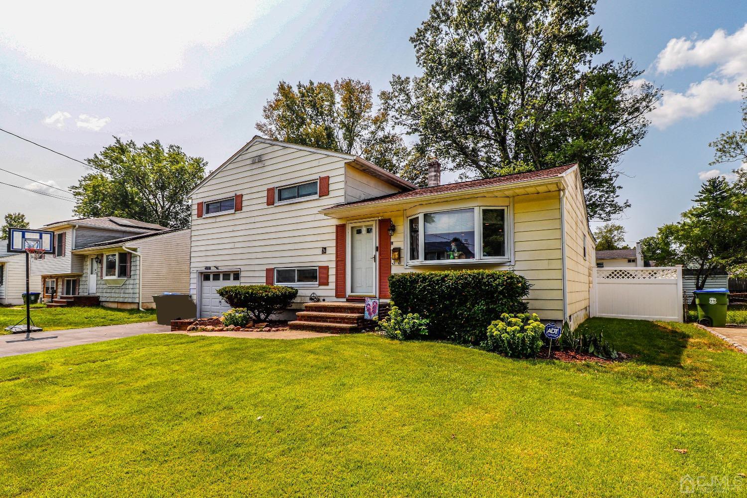 24 Finley Road Edison, NJ 08817 - Photo 3 of 27 a front view of house with yard and trees in the background