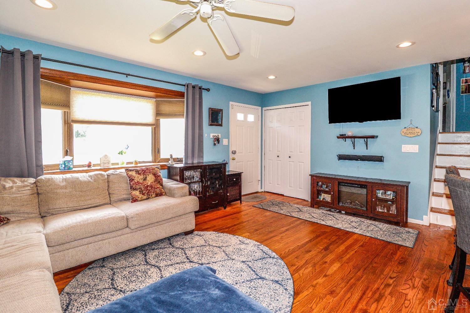 24 Finley Road Edison, NJ 08817 - Photo 7 of 27 a living room with fireplace furniture and a flat screen tv